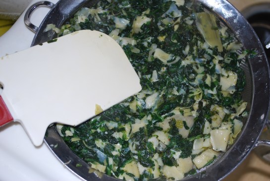 Drain water out of spinach artichoke mixture and place in mixing bowl